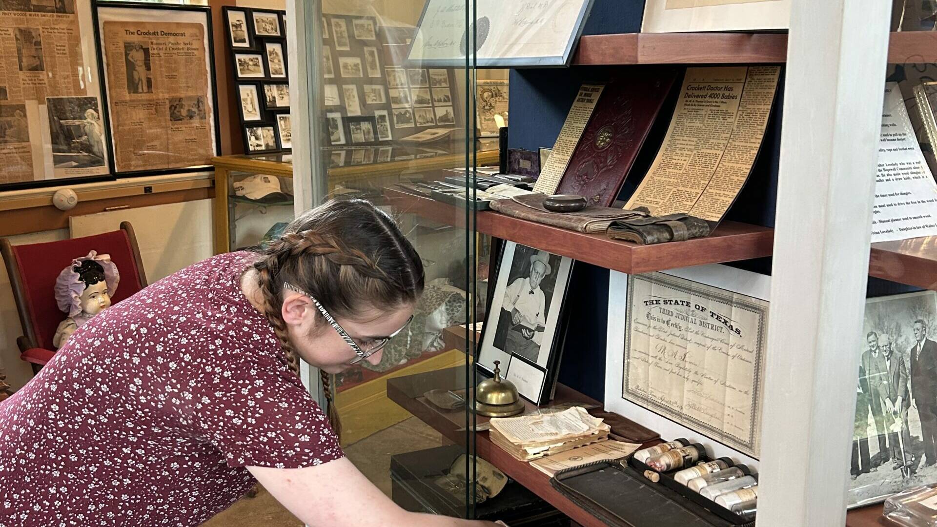 A student from Stephen F. Austin searches items at the museum for possible digitizing efforts