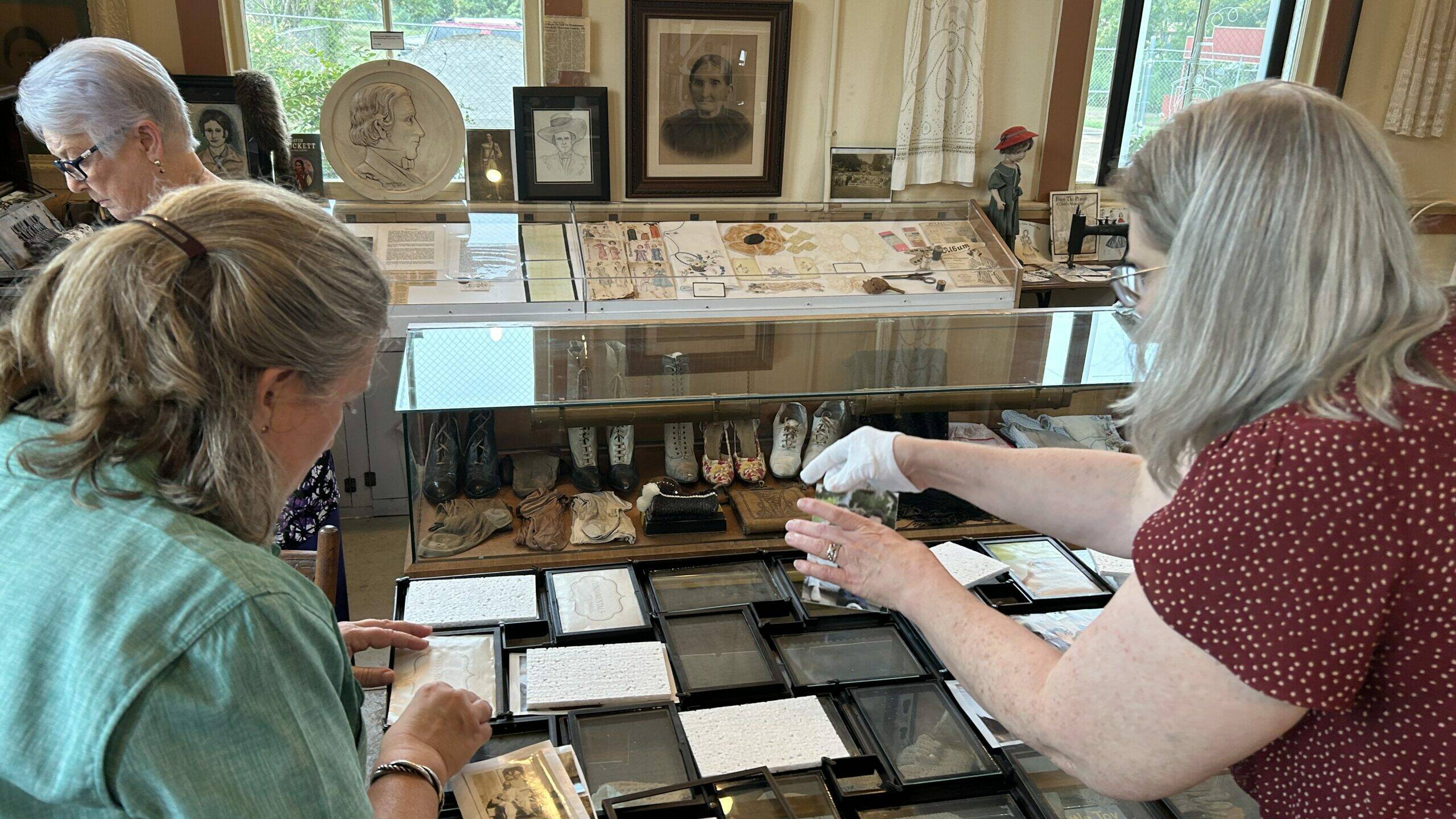 Perky Beisel (left) goes through items in the museum to decide what to digitize and preserve