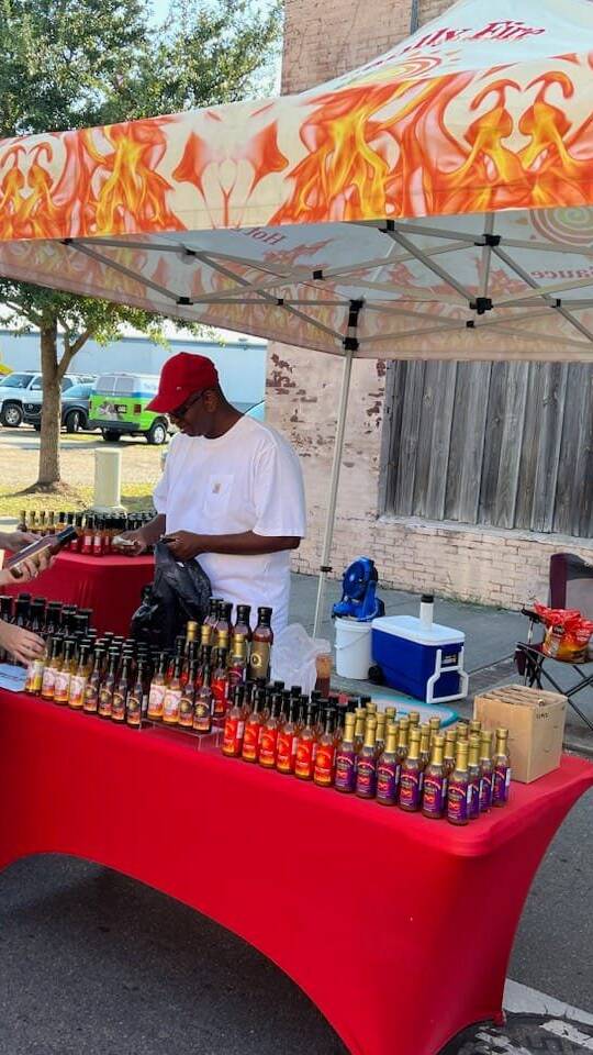 James Louis at a tent selling hot sauce